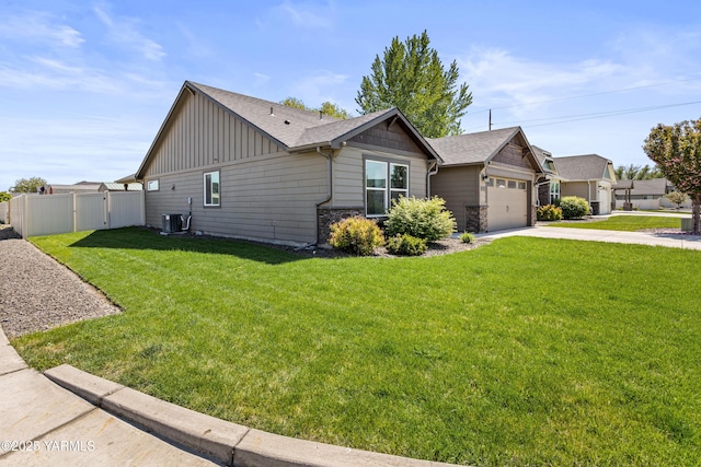 2201 S 62nd Ave, Yakima, WA 98903 - view of front of property featuring board and batten siding, concrete driveway, central air condition unit, stone siding, and a garage