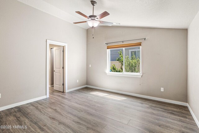 2201 S 62nd Ave, Yakima, WA 98903 - spare room featuring vaulted ceiling, ceiling fan, wood finished floors, and baseboards