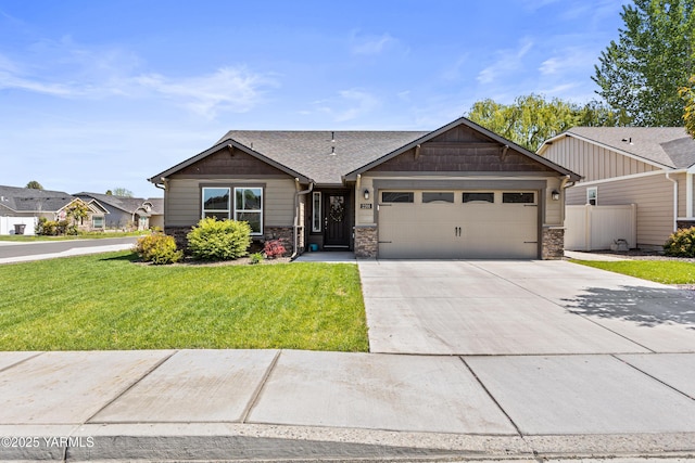 2201 S 62nd Ave, Yakima, WA 98903 - craftsman house featuring a garage, stone siding, driveway, and a shingled roof