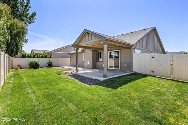 2201 S 62nd Ave, Yakima, WA 98903 - back of house featuring a patio, a gate, board and batten siding, and a shingled roof