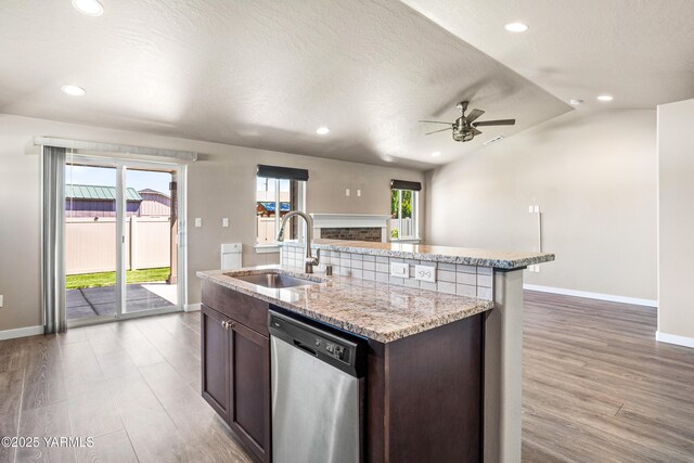 2201 S 62nd Ave, Yakima, WA 98903 - kitchen with stainless steel dishwasher, a sink, baseboards, wood finished floors, and open floor plan