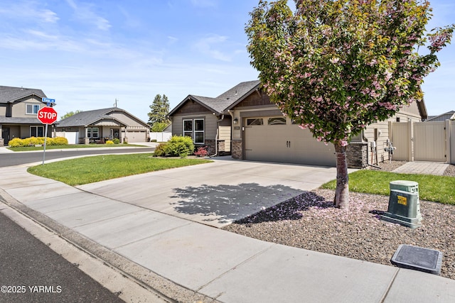 2201 S 62nd Ave, Yakima, WA 98903 - view of front of property with concrete driveway, a gate, a garage, and stone siding