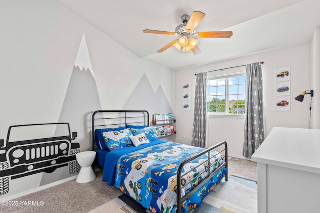 carpeted bedroom with baseboards and a ceiling fan