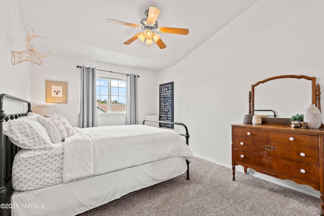 carpeted bedroom with baseboards, ceiling fan, and vaulted ceiling