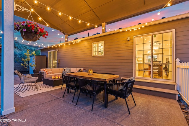 view of patio / terrace with an outdoor living space with a fire pit and outdoor dining area