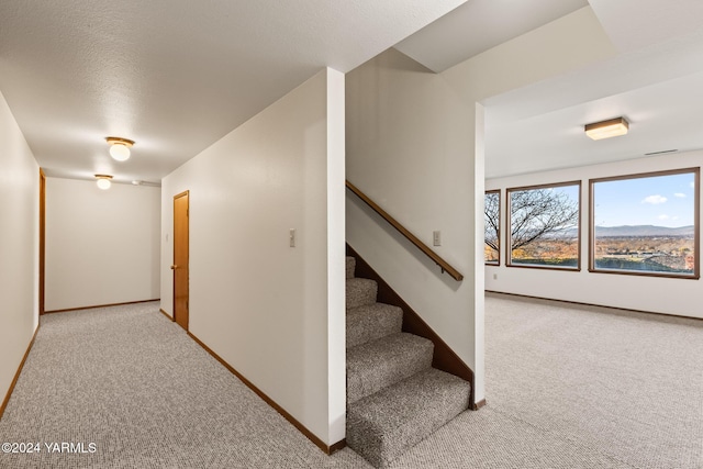 stairs with baseboards and carpet flooring