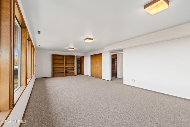 carpeted spare room featuring visible vents