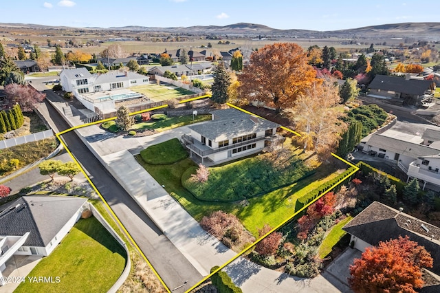 birds eye view of property with a mountain view and a residential view