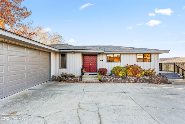 single story home featuring driveway and an attached garage