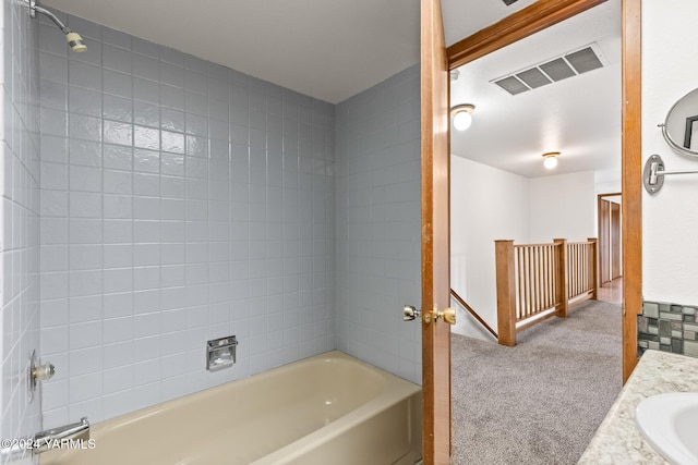 bathroom featuring bathtub / shower combination, visible vents, and vanity