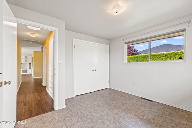 220 N 42nd Ave, Yakima, WA 98908 - unfurnished bedroom featuring stone finish floor, a closet, baseboards, and visible vents