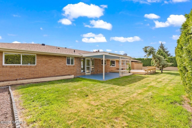 220 N 42nd Ave, Yakima, WA 98908 - rear view of property with a lawn, brick siding, a deck, and a patio