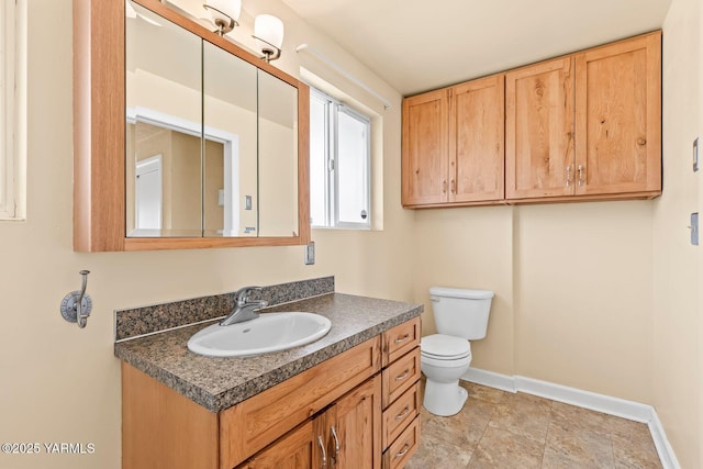 220 N 42nd Ave, Yakima, WA 98908 - bathroom with baseboards, toilet, and vanity