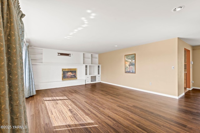 220 N 42nd Ave, Yakima, WA 98908 - unfurnished living room featuring wood finished floors, built in features, a fireplace, baseboards, and recessed lighting