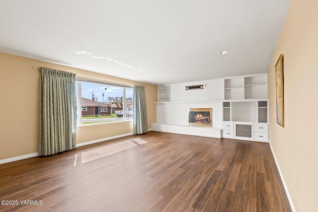 220 N 42nd Ave, Yakima, WA 98908 - unfurnished living room with wood finished floors, baseboards, and a brick fireplace