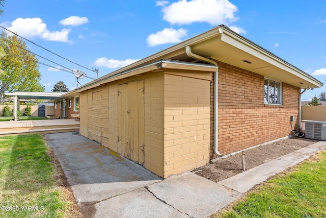 220 N 42nd Ave, Yakima, WA 98908 - view of side of home with brick siding and central air condition unit