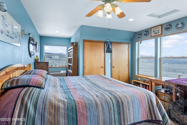 bedroom featuring a wall mounted air conditioner, a ceiling fan, and recessed lighting