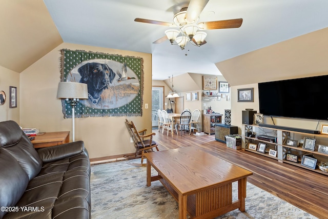 living area with lofted ceiling, ceiling fan, and wood finished floors