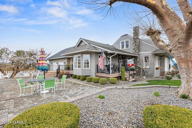 31 Gilbert Rd, Zillah, WA 98953 - rear view of house featuring stucco siding, a patio area, and roof with shingles