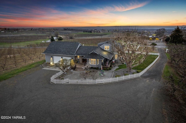 31 Gilbert Rd, Zillah, WA 98953 - view of front of home with a fenced front yard, an attached garage, and dirt driveway