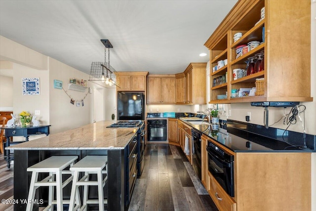 31 Gilbert Rd, Zillah, WA 98953 - kitchen with black appliances, open shelves, a center island, dark wood-type flooring, and light stone countertops