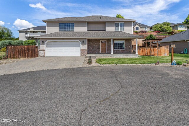 7511 Maclaren St, Yakima, WA 98908 - view of front of property featuring asphalt driveway, brick siding, an attached garage, and roof with shingles