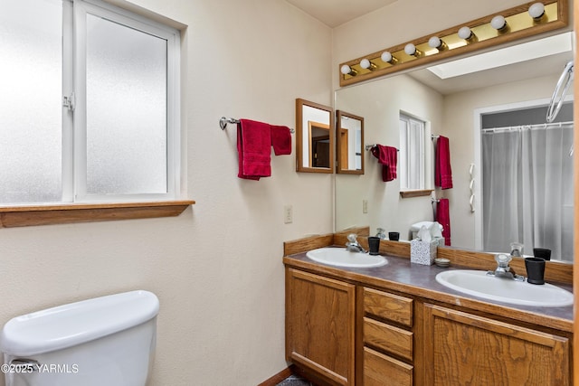 bathroom with a shower with shower curtain, a sink, toilet, and double vanity