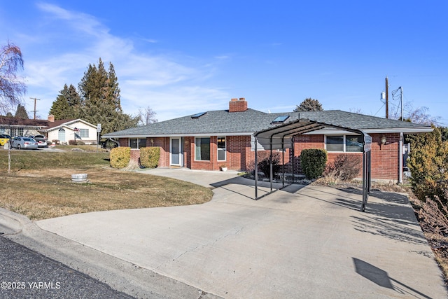 ranch-style house with a shingled roof, a chimney, a front lawn, and brick siding