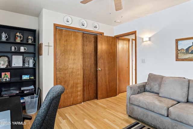 office area with light wood-style flooring and a ceiling fan
