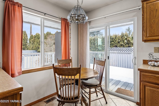 dining room featuring a chandelier, plenty of natural light, and visible vents
