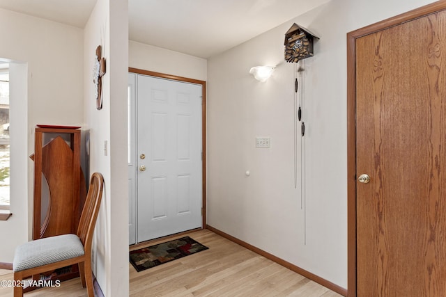 entrance foyer featuring light wood-style flooring and baseboards