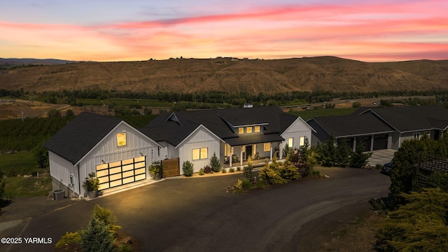 4611 Hilltop Way, Yakima, WA 98908 - modern farmhouse style home featuring board and batten siding, driveway, a mountain view, and a garage