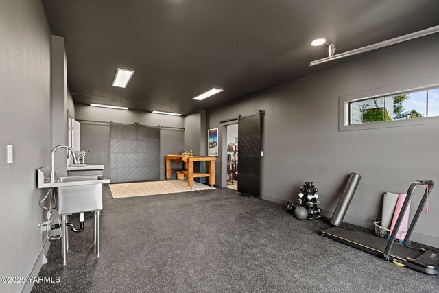 4611 Hilltop Way, Yakima, WA 98908 - miscellaneous room featuring a barn door, a sink, and baseboards