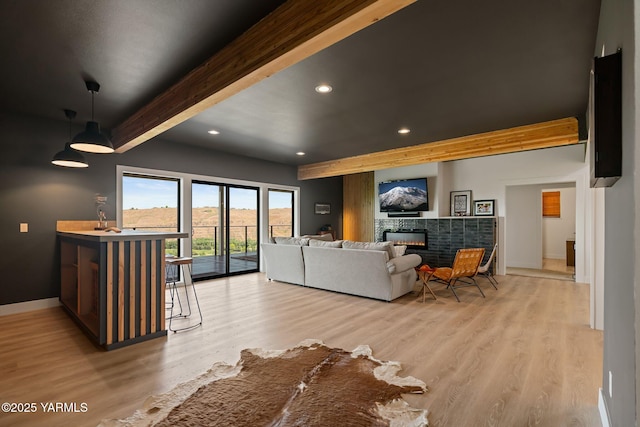 4611 Hilltop Way, Yakima, WA 98908 - living area with beamed ceiling, recessed lighting, baseboards, light wood-style floors, and a glass covered fireplace