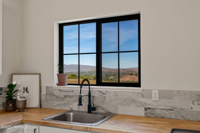 4611 Hilltop Way, Yakima, WA 98908 - kitchen with a sink, a mountain view, backsplash, and healthy amount of natural light