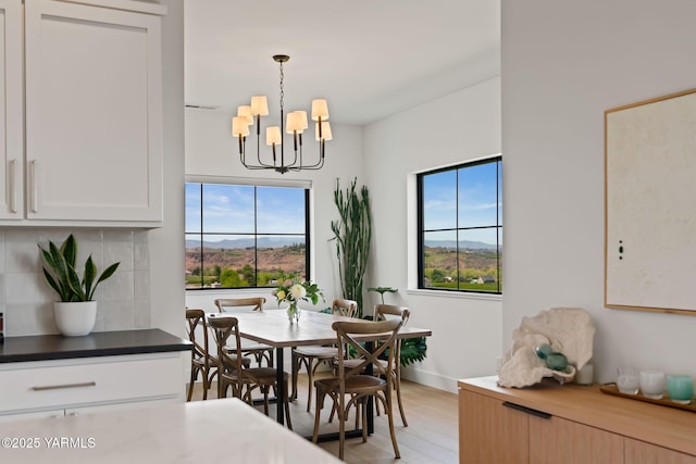 4611 Hilltop Way, Yakima, WA 98908 - dining room with a chandelier, light wood-type flooring, baseboards, and a mountain view
