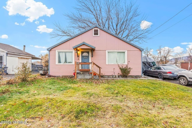 bungalow-style home featuring a front yard