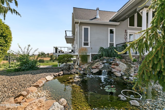 921 Tibbling Rd, Selah, WA 98942 - view of side of property with a shingled roof and a small pond