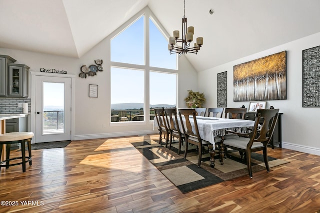 921 Tibbling Rd, Selah, WA 98942 - dining space featuring high vaulted ceiling, a chandelier, and dark wood-type flooring