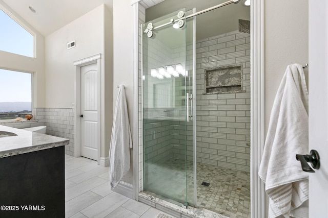 921 Tibbling Rd, Selah, WA 98942 - full bath with a shower stall, vanity, tile walls, and lofted ceiling