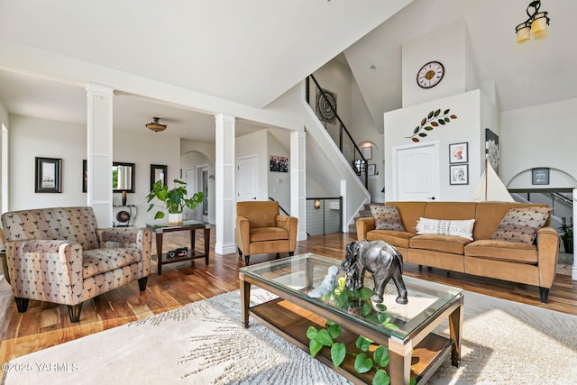 921 Tibbling Rd, Selah, WA 98942 - living area with ornate columns, wood finished floors, stairs, and a high ceiling