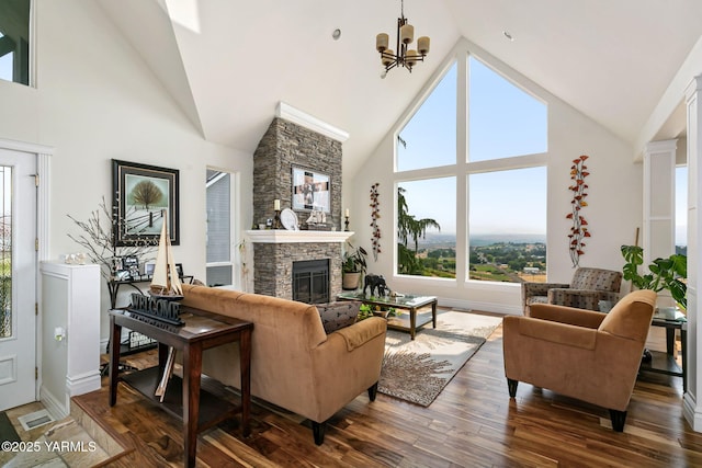 921 Tibbling Rd, Selah, WA 98942 - living room featuring high vaulted ceiling, a fireplace, a chandelier, and wood finished floors