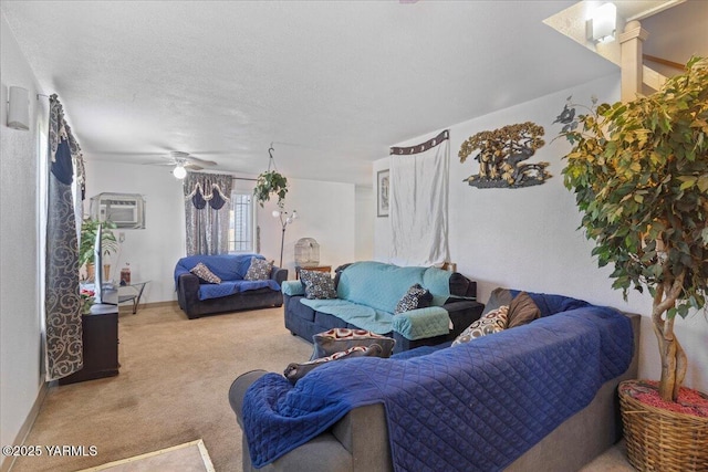 carpeted living room featuring a wall mounted AC, a ceiling fan, and ornate columns