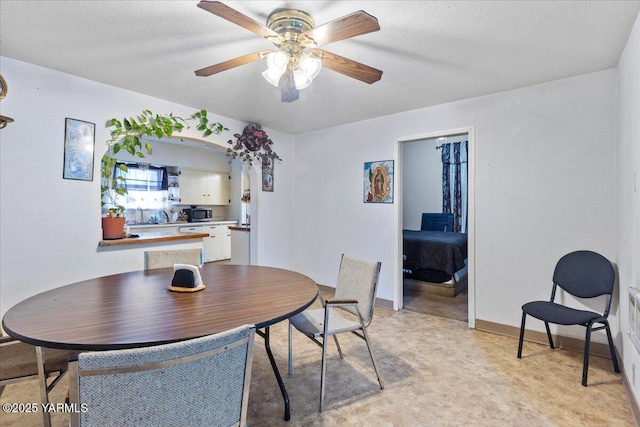 dining area featuring a ceiling fan and baseboards
