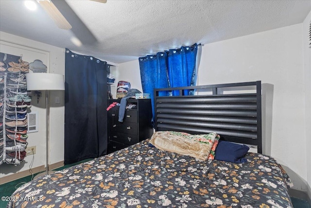 bedroom featuring carpet, a textured ceiling, and ceiling fan
