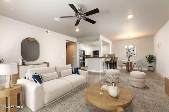 8905 Occidental Rd Unit 202A, Yakima, WA 98903 - living room featuring a ceiling fan, a chandelier, recessed lighting, light carpet, and baseboards