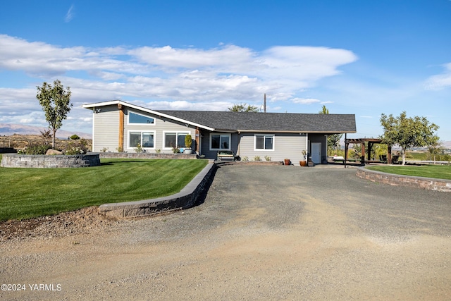 view of front of home with dirt driveway, a front lawn, and a pergola