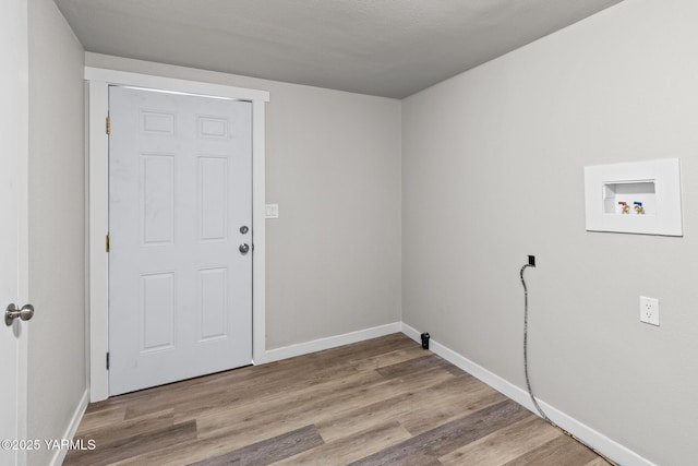 laundry room featuring wood finished floors, hookup for a washing machine, baseboards, and laundry area