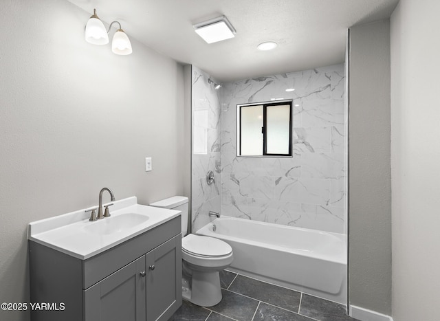 bathroom with tile patterned flooring, toilet, vanity, and bathtub / shower combination