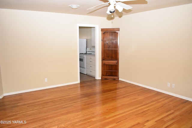 empty room featuring baseboards, light wood-style floors, and a ceiling fan